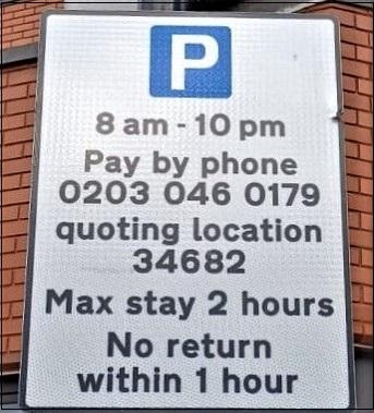 Sign with white P in blue box saying Pay by phone