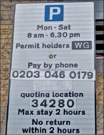 Parking sign saying permit holders or pay by phone.