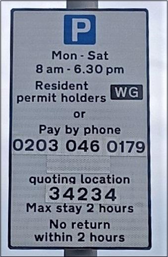 Parking sign showing times to pay, and how to pay, for parking.