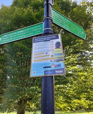 A poster about antisocial behaviour attached to a signpost
