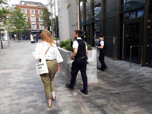 A woman and a police officer walking next to each other