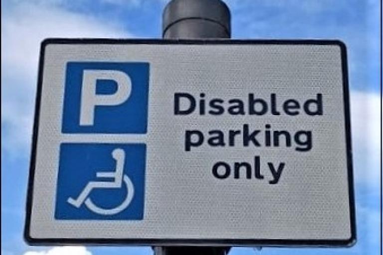 Parking sign with a white P in a blue square saying disable parking only.