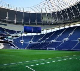 The inside of Tottenham Hotspur Football stadium showing the pitch and stands